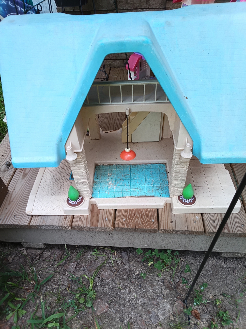 Plastic Playhouse with Bright Blue Roof and Orange Pendant Light
